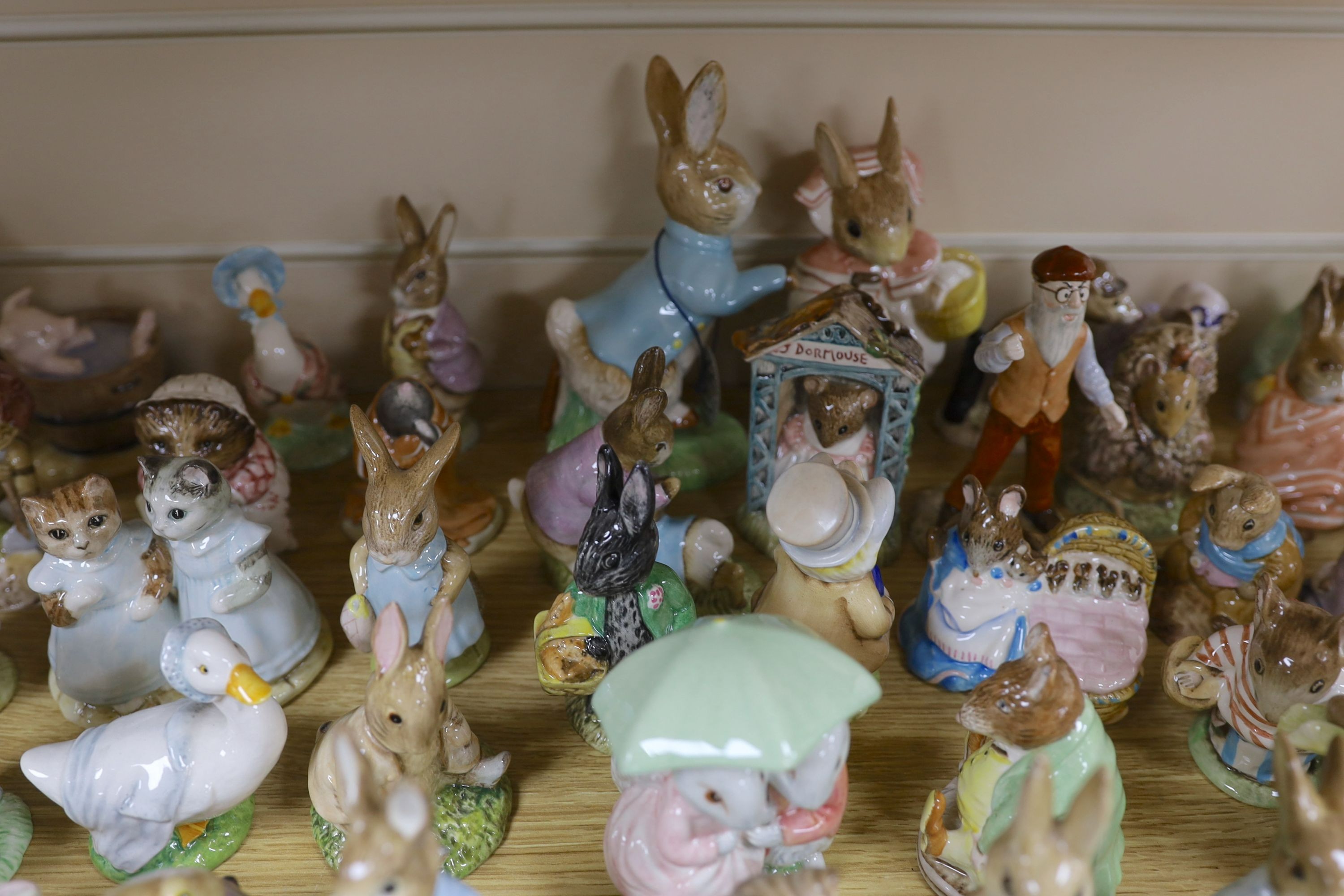 A large collection of Beatrix Potter ceramic figures by Royal Doulton, Beswick and Royal Albert, to include ‘Sir Isaac Newton’ and ‘Mr McGregor’